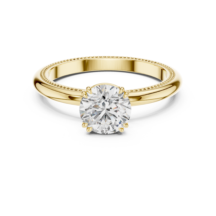 1 carat 6.5mm round lab-grown diamond engagement ring named The Aurelia featuring a yellow gold band with vintage milgrain edges by The Brillora Jewellery House, isolated on a black background.