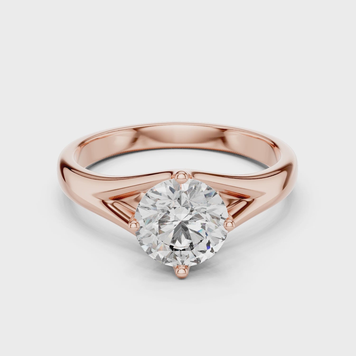 1 carat 6.5mm round lab-grown diamond engagement ring named The Lyra featuring a sweeping split shank rose gold band by The Brillora Jewellery House, isolated on a black background.